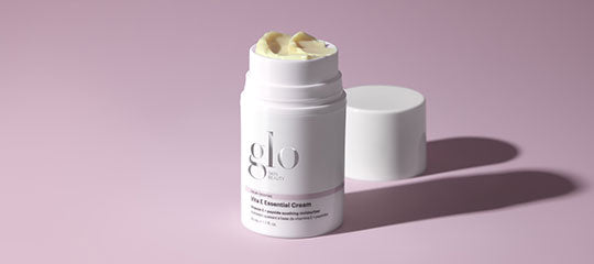 White glo cream component with lid off showing cream, on a pink background