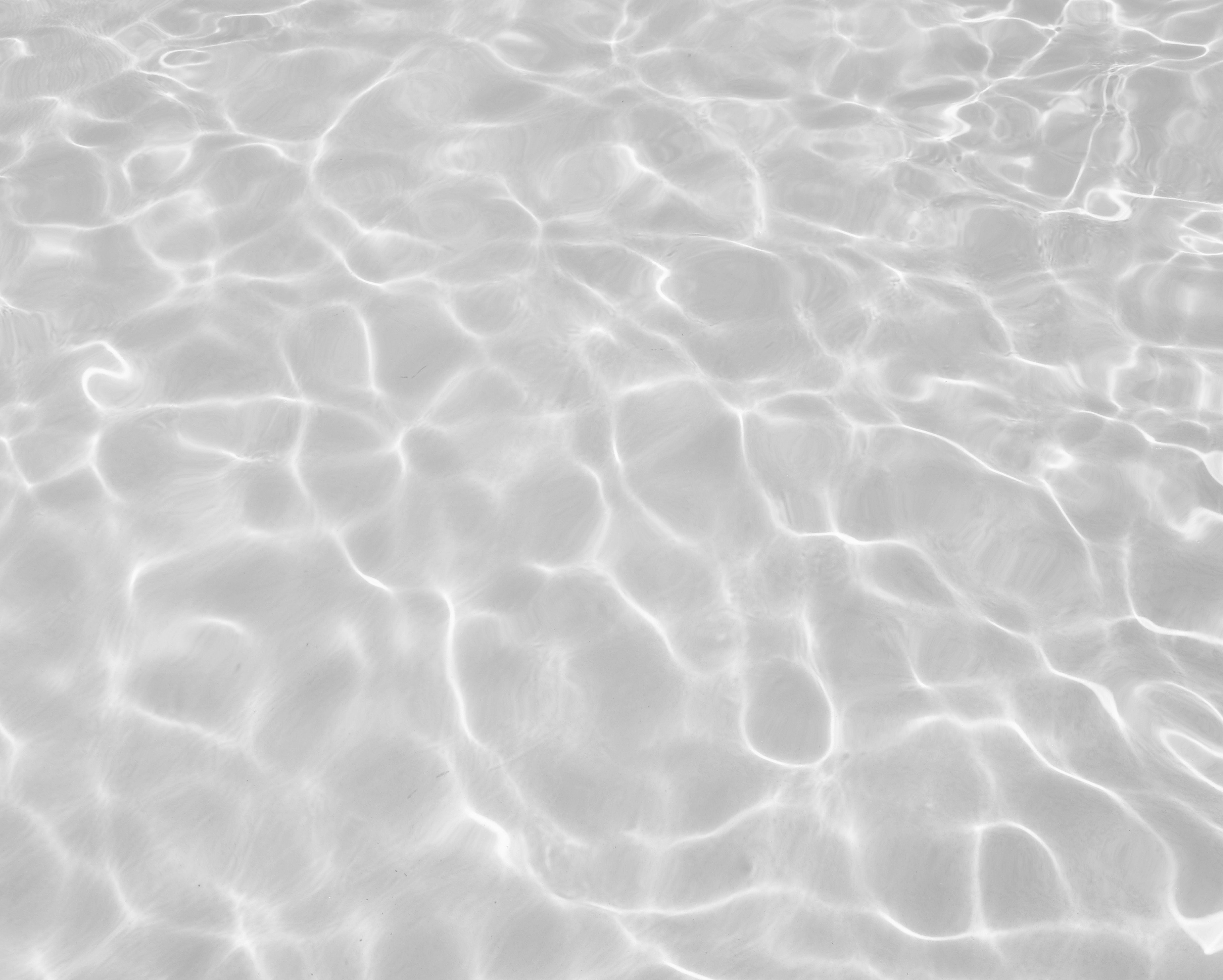 Sunlit water surface with rippling light patterns and soft reflections