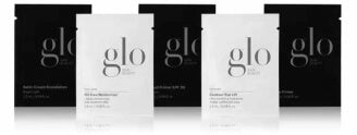 Four black and white cosmetic product sample packets with 'glo' logo repeated across them