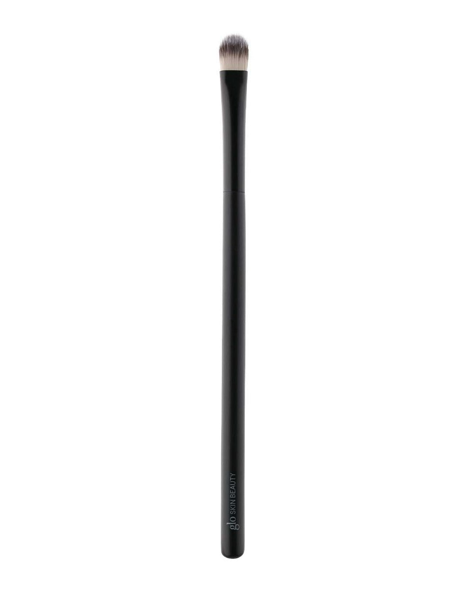Black eyeshadow brush with rounded dense bristles, glo SKIN BEAUTY printed on handle.