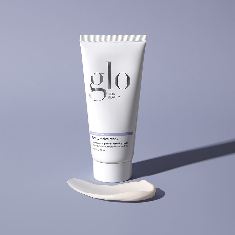 Tube of Glo Skin Beauty Restorative Mask with squalane and superfruit, with cream swatch on purple background