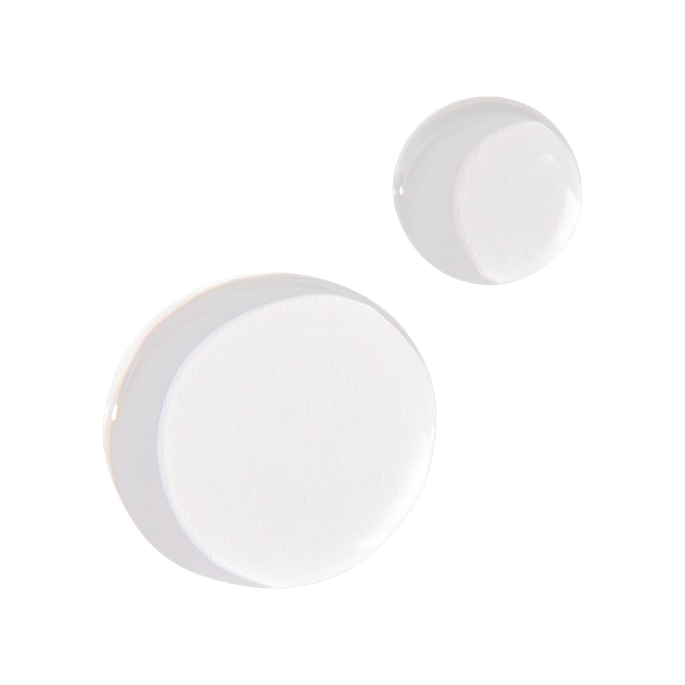 Two round white cotton pads with glossy clear serum droplets on a white background