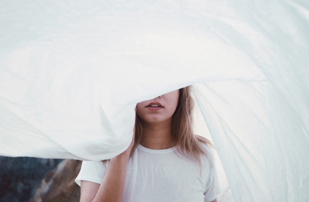 woman with while material over eyes