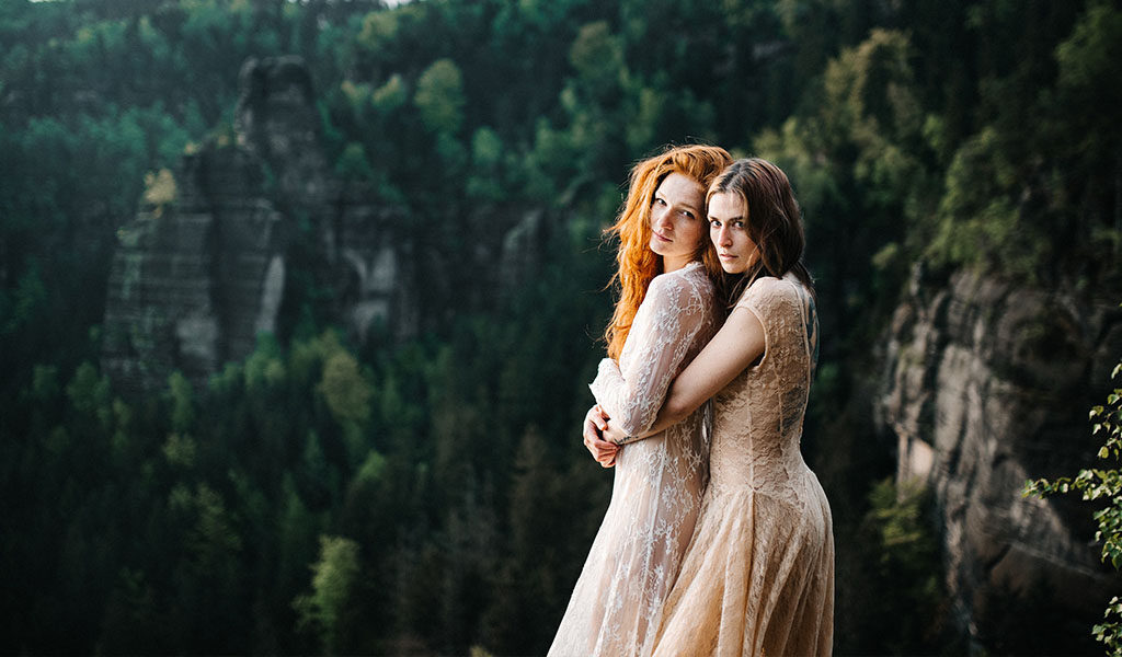 Two brides posing with modern wedding day makeup