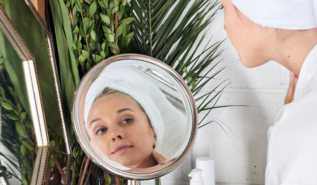 Woman looking in mirror