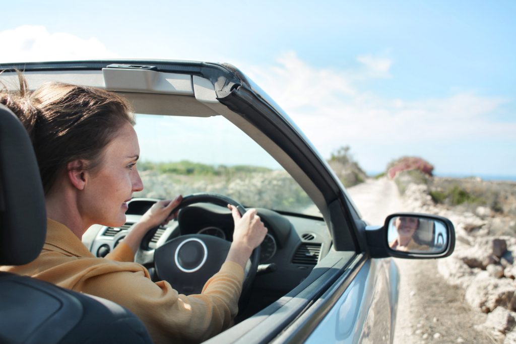 woman driving convertible car