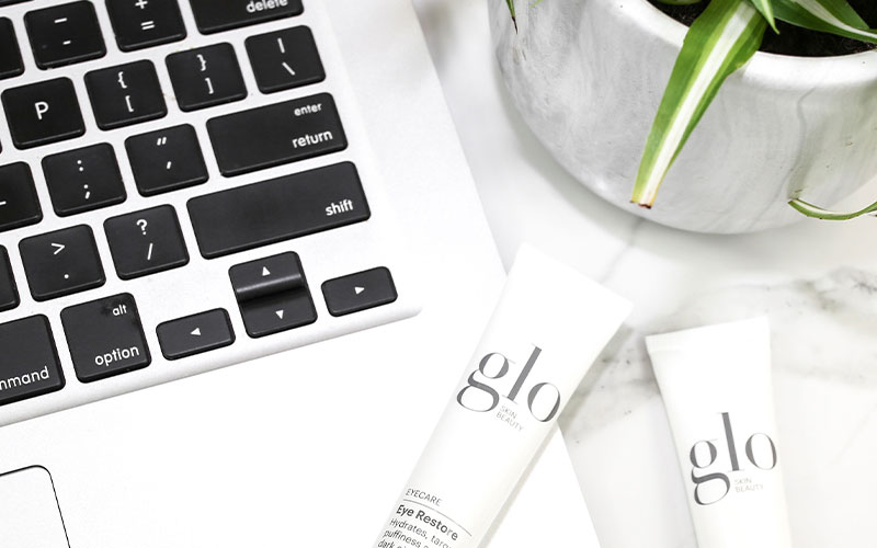 glo skin beauty eye restore next to computer