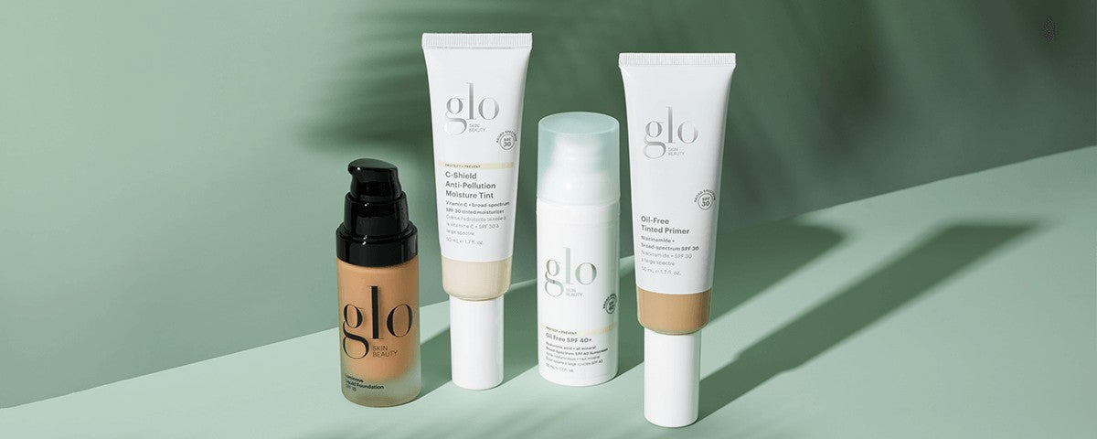 Four glo skin beauty tubes and a pump foundation displayed on a green background.