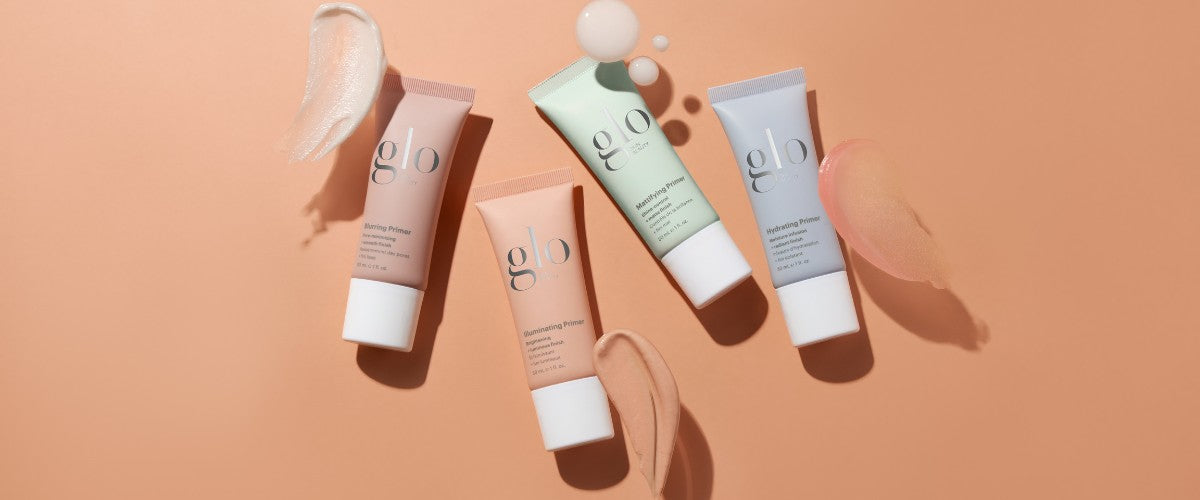 Four tubes labeled "glo" — Blurring Primer, Illuminating Primer, Mattifying Primer, Hydrating Primer — with swatches on peach