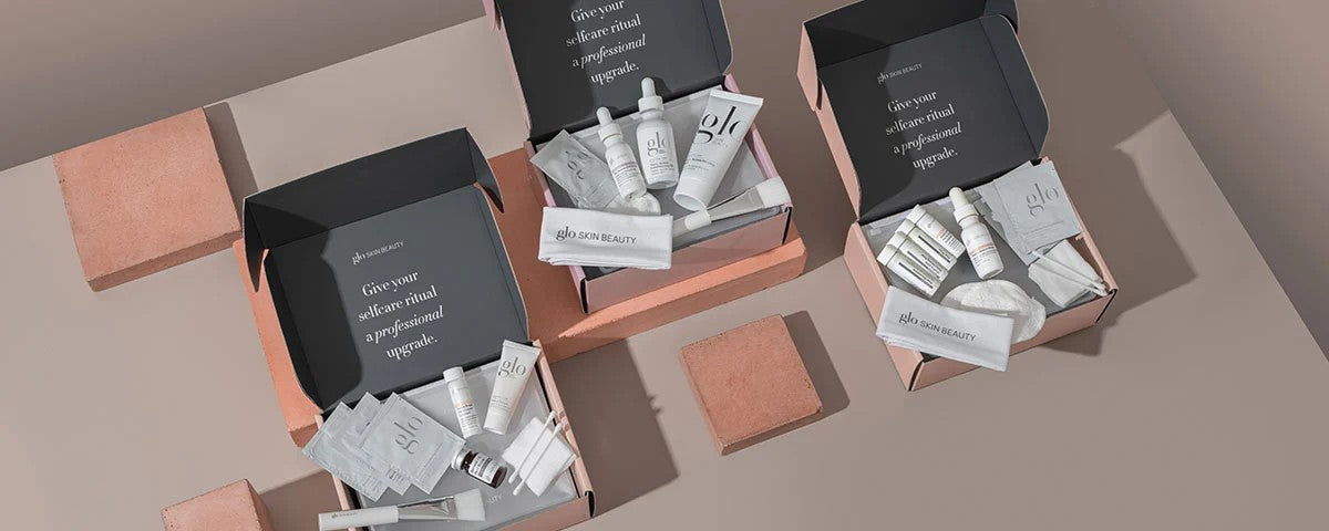 Three open pink boxes of peel kits - Give your selfcare ritual a professional upgrade. glo SKIN BEAUTY
