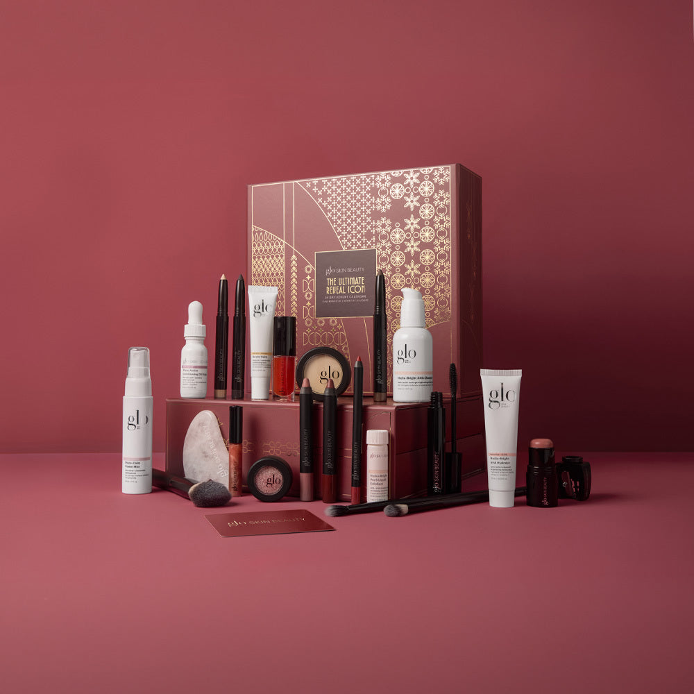 Styled view of The Ultimate Reveal Icon beauty collection showcasing makeup and skincare products with a burgundy gift box