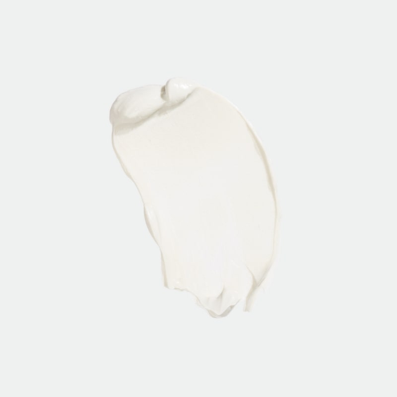 Sunscreen cream smear on pale background