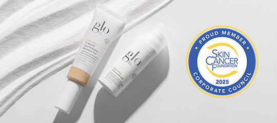 Two glo tubes on white textured surface with badge reading: PROUD MEMBER, SKIN CANCER FOUNDATION, CORPORATE COUNCIL, 2025.
