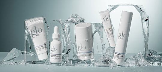 glo skincare products arranged on melting ice blocks, five tubes and jars with condensation
