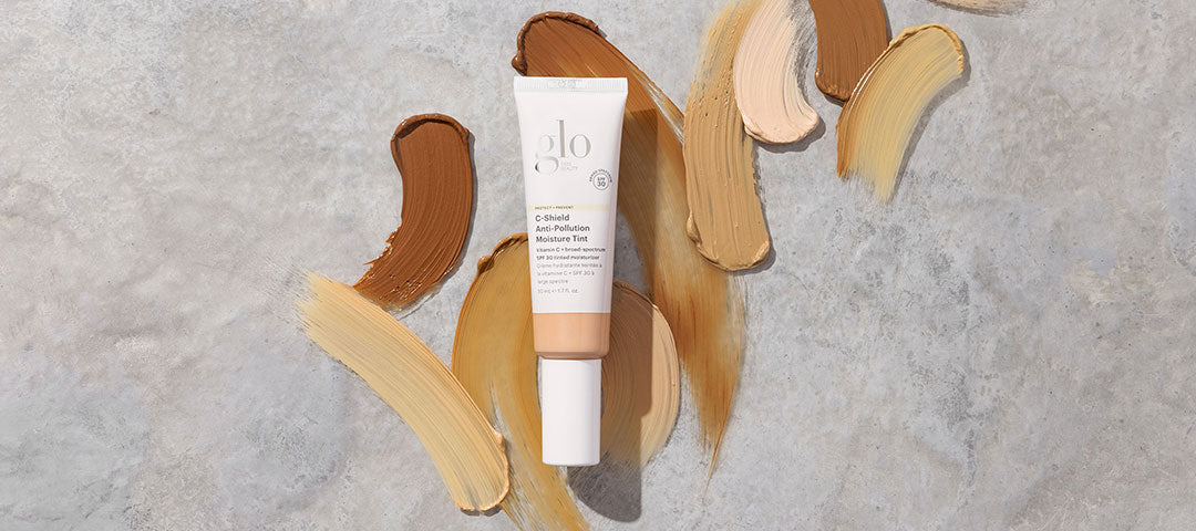 Top view of C-Shield Anti-Pollution Moisture Tint SPF 30 tube showing multiple foundation swatches on a concrete background