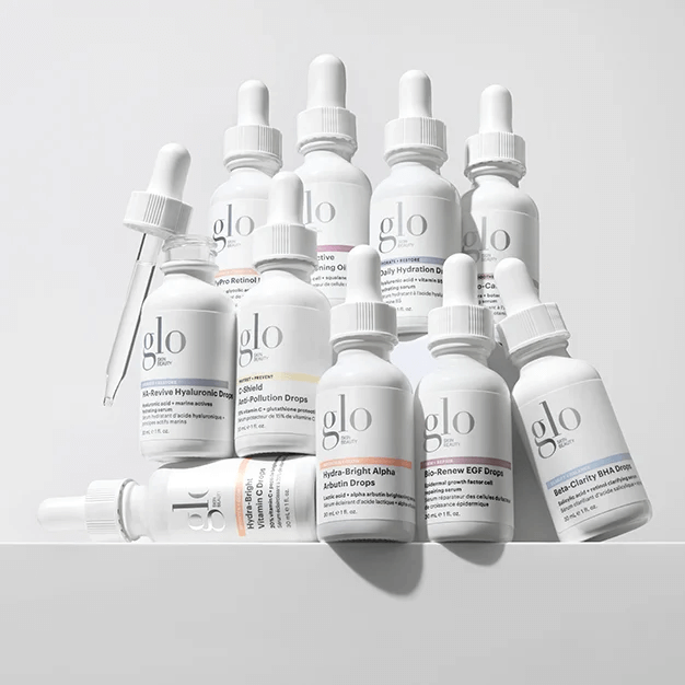 Assorted white glo dropper bottles arranged on a shelf; multiple 'glo' logos visible.