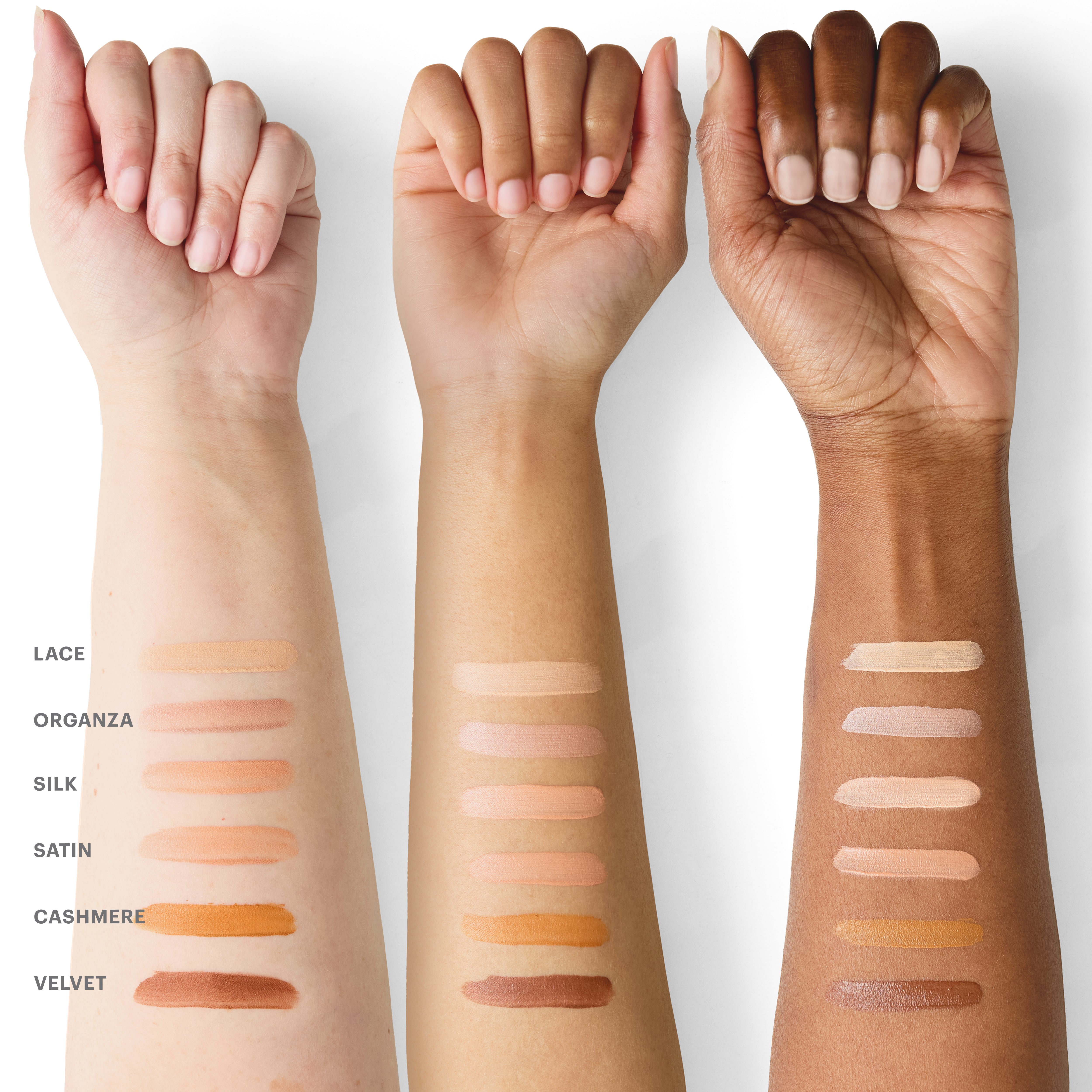 Three forearms with six foundation swatches labeled LACE ORGANZA SILK SATIN CASHMERE VELVET across light-to-deep skin tones