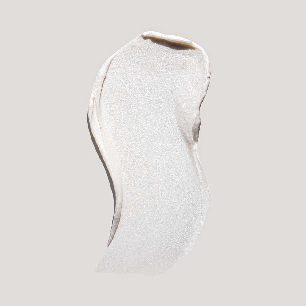 Sheer white cosmetic cream smear with smooth textured surface on pale gray background