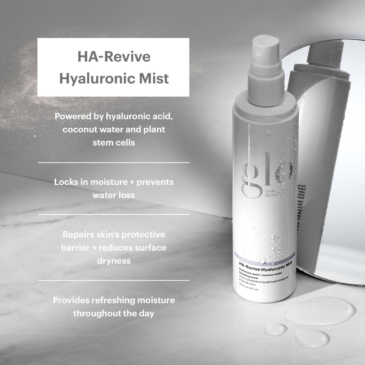 Bottle of HA-Revive Hyaluronic Mist with water droplets and mirror reflection, showing text: HA-Revive Hyaluronic Mist, Hyaluronic acid + coconut water Hydrating toner