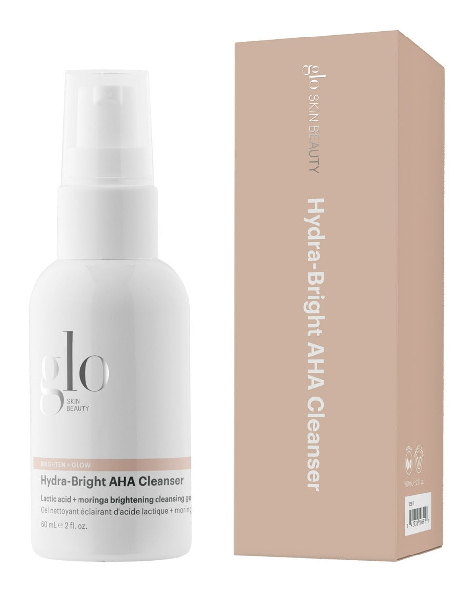 Glo Skin Beauty Hydra-Bright AHA Cleanser pump bottle beside beige product box, front labels visible.