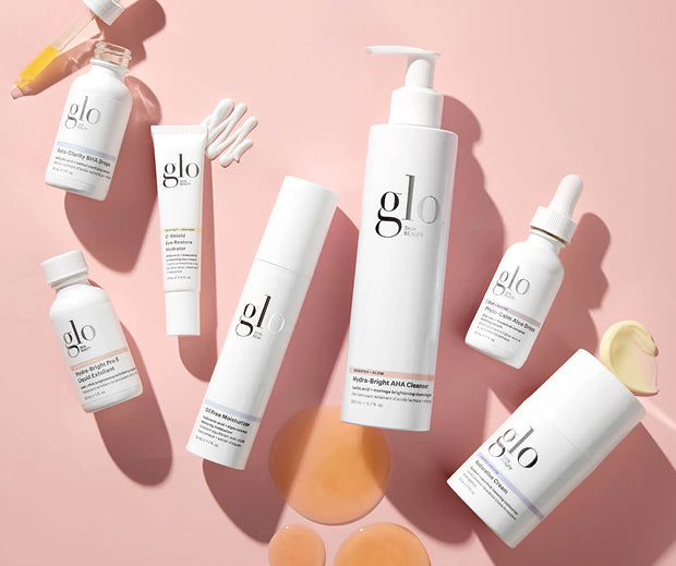 White glo skin beauty products on pink background; central pump labeled Hydra-Bright AHA Cleanser.