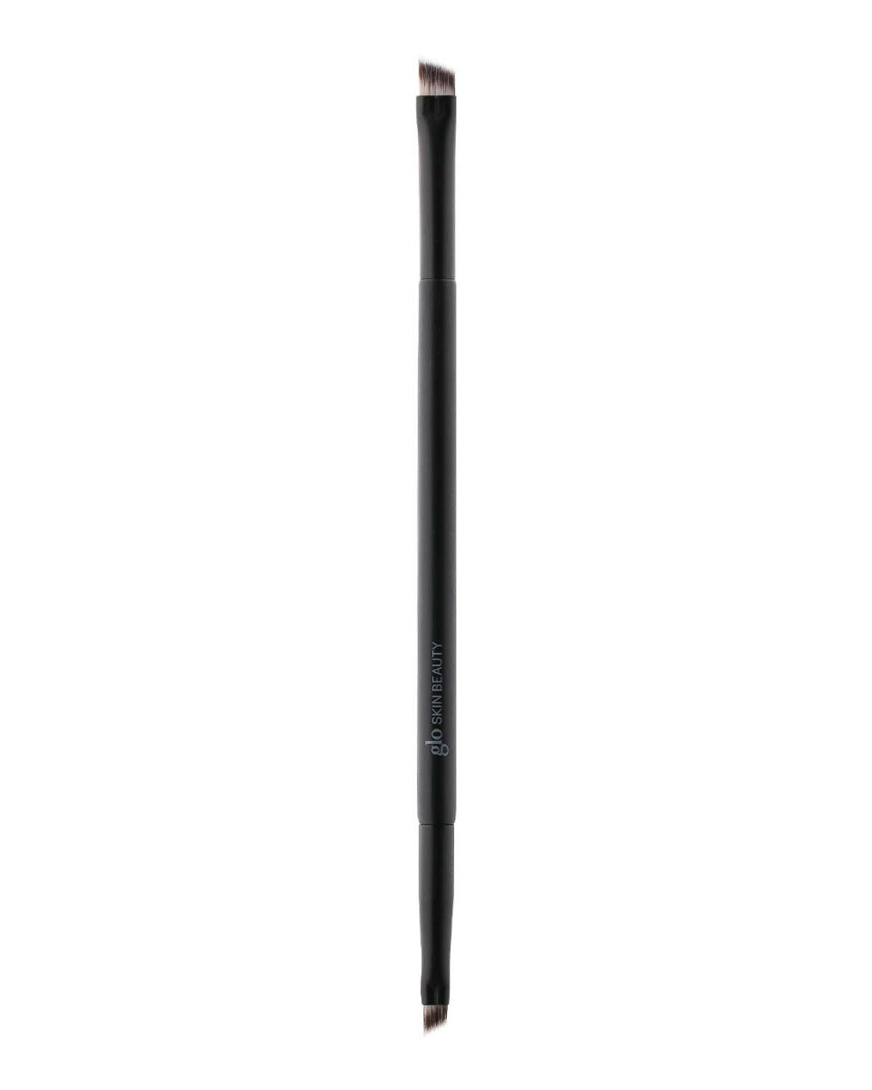 Double-ended angled eyebrow brush with black handle, 'glo SKIN BEAUTY' printed on the handle.