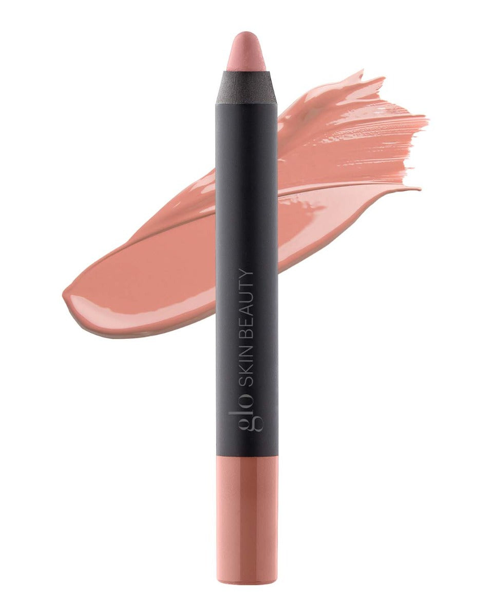 Nude-pink lip crayon with matching smear behind, black barrel labeled glo SKIN BEAUTY