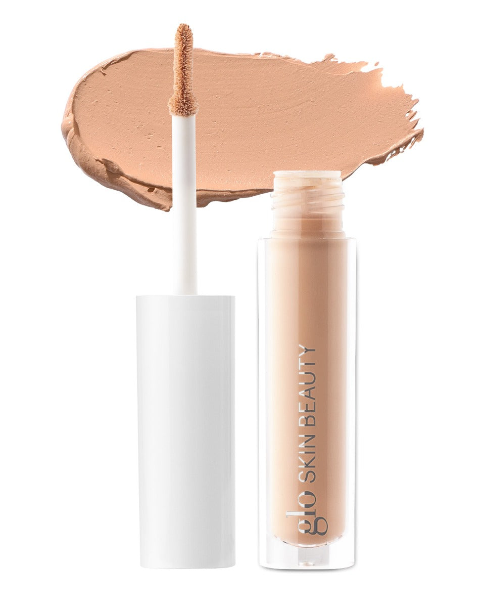 Concealer tube with applicator and swatch, labeled 'glo SKIN BEAUTY'