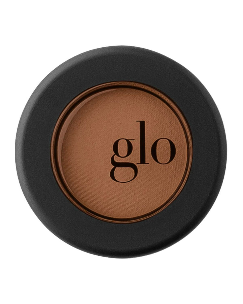 Brown glo eyeshadow in black round container