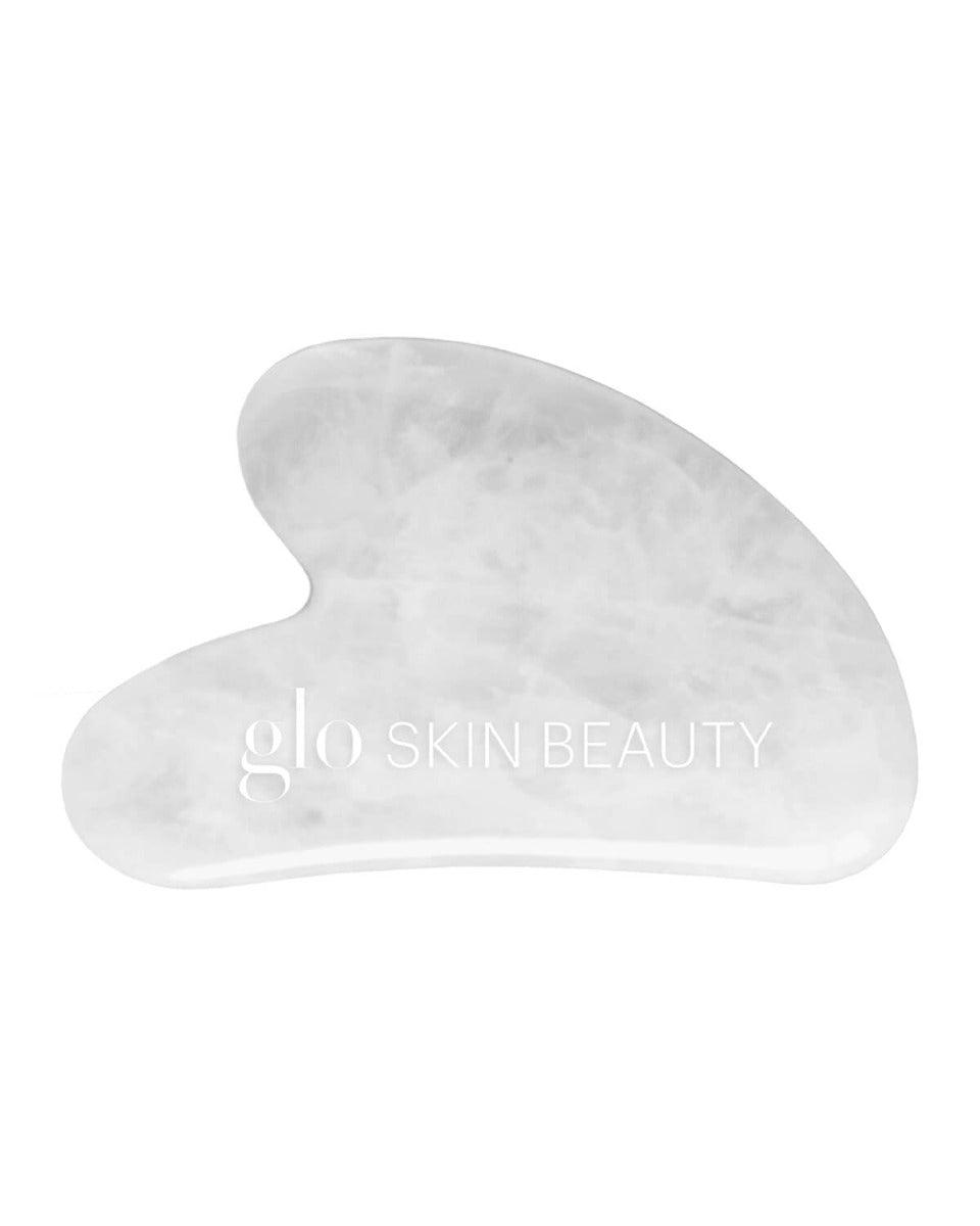 White jade gua sha stone with glo SKIN BEAUTY logo
