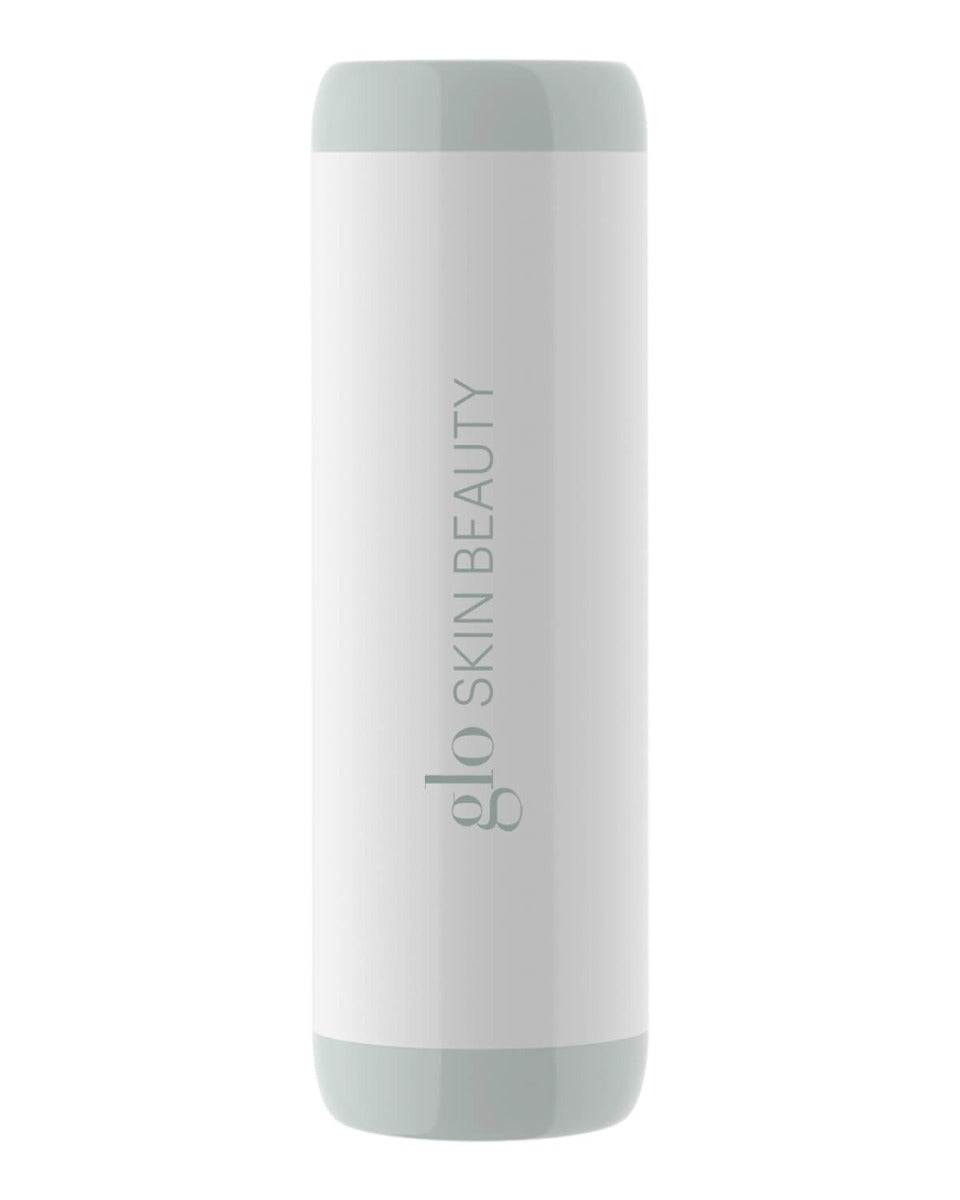 Cylindrical device with text 'glo SKIN BEAUTY' on it