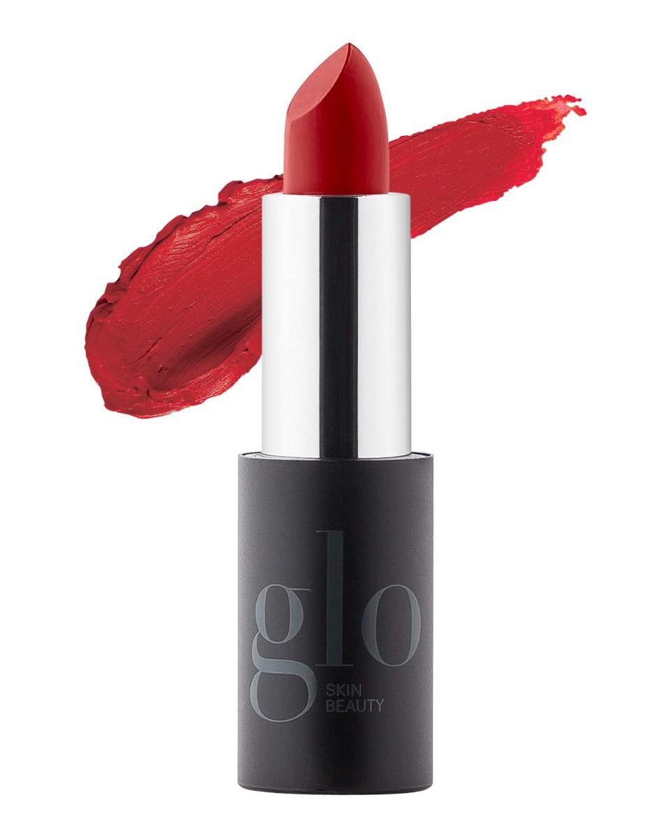 Red lipstick with smeared swatch behind, black tube labeled glo SKIN BEAUTY.