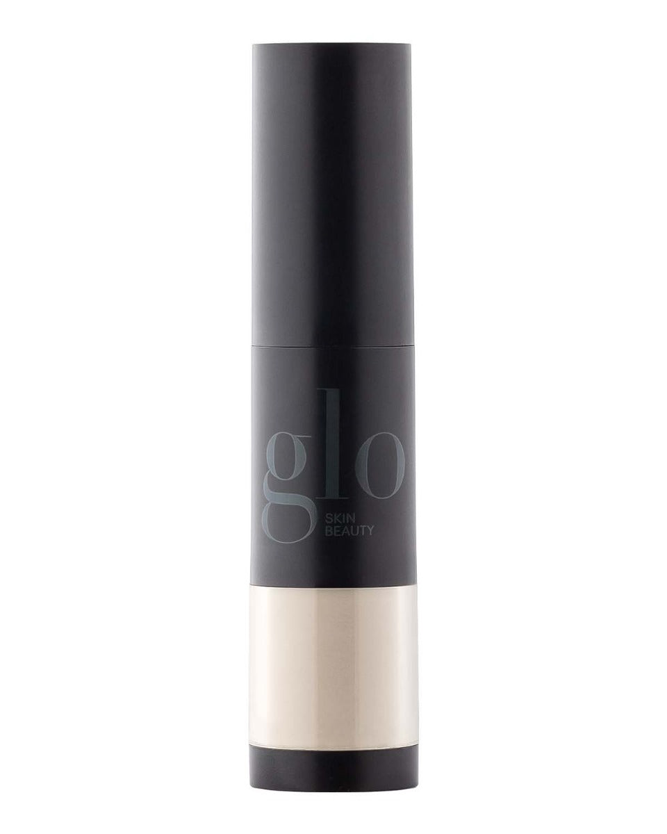 Black cylindrical bottle labeled glo SKIN BEAUTY, black cap and beige product visible in clear lower chamber.