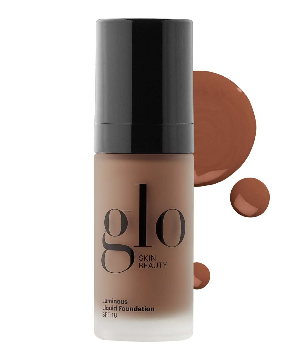 glo SKIN BEAUTY Luminous Liquid Foundation SPF 18 bottle with medium-deep shade and two foundation swatches