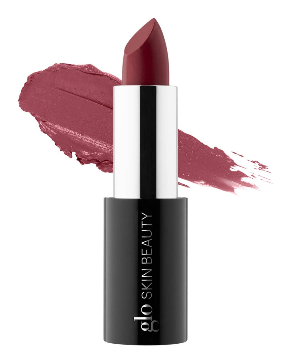Mauve lipstick bullet and matching smear, black tube labeled glo SKIN BEAUTY