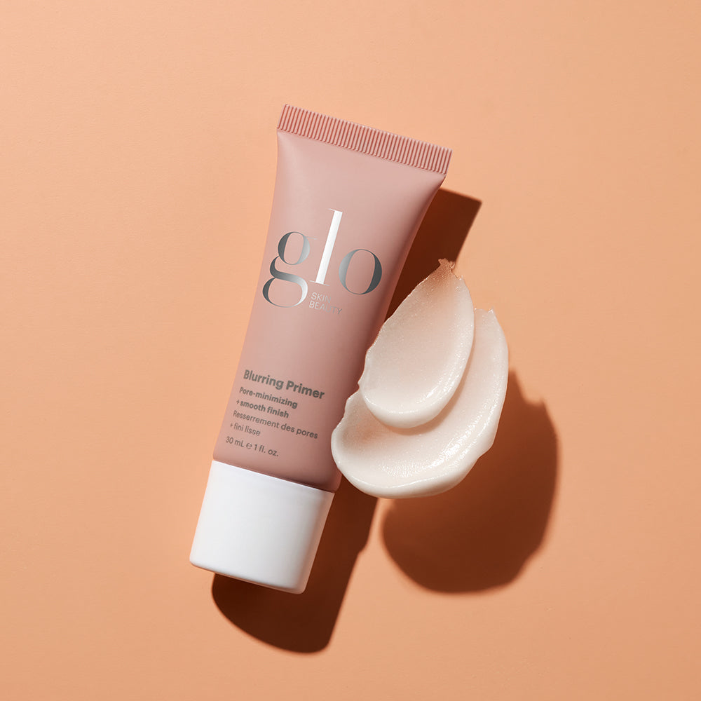 glo Blurring Primer tube on peach background with two swipes of primer