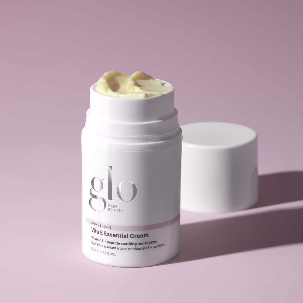 Glo Skin Beauty Vita E Essential Cream moisturizer container with cream on top and detached lid