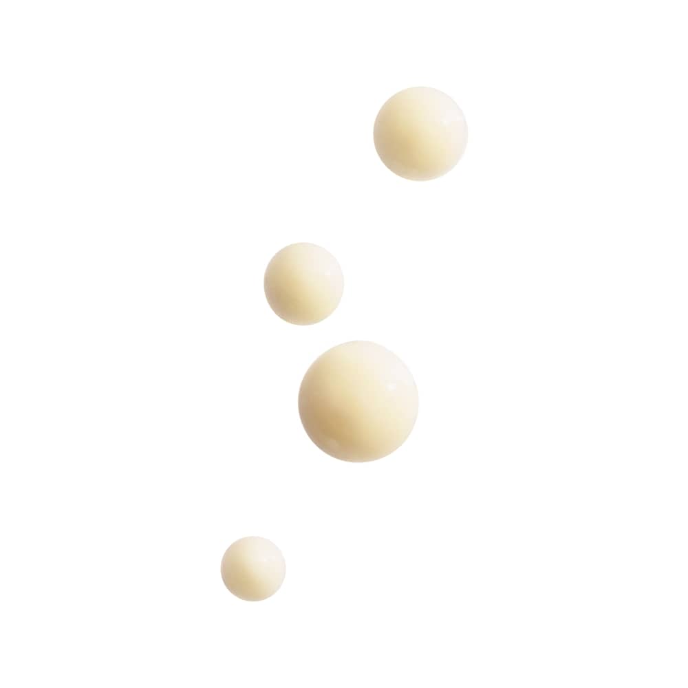 Four beige cream drops of varying sizes on a white background