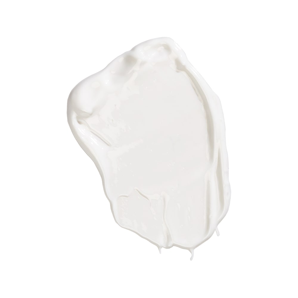 Smear of white cream sunscreen labeled Oil Free SPF 40+